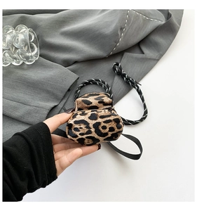 Close-up of mini leopard print crossbody bag with woven strap for girls and outdoor travel