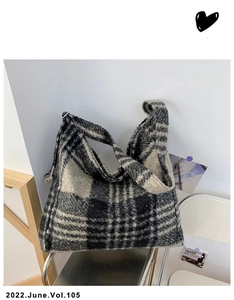 Macro detail of soft checkered wool tote bag with large black and white pattern