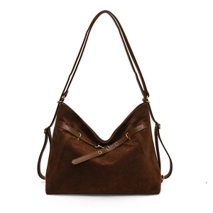 Deep brown suede tote bag with decorative leather straps and gold metal hardware accents