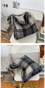 Detail showing soft black and white plaid wool texture on a large shoulder tote bag