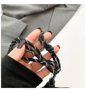 Macro shot of black and white woven lanyard detail with durable plastic tips and metal hook