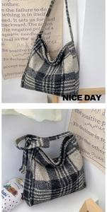 Detailed view of large plaid tote bag in thick tweed fabric with wide shoulder strap