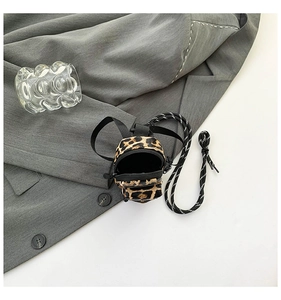 Close-up of mini leopard print crossbody bag with velvet texture and zipper pocket