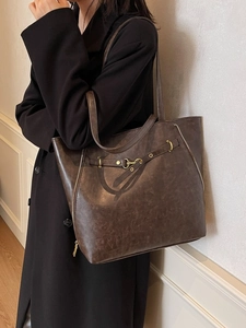 Retro large brown leather tote bag with zippers and buckle, versatile crossbody backpack