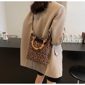Dettaglio della borsa tote leopardata con manici in bambù e tracolla regolabile