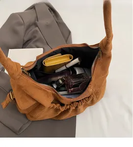 Spacious interior of brown suede tote bag showing everyday essentials and storage