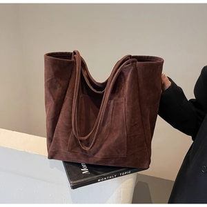 Detailed view of the large dark brown suede tote bag with front pocket for daily commute