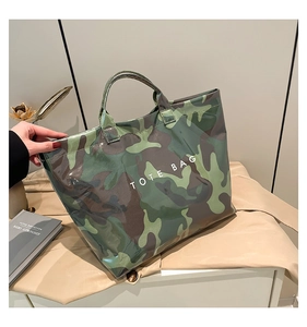 Detail of camouflage print tote bag with white lettering and glossy waterproof finish
