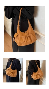 Macro detail of mustard yellow suede tote bag with pleated texture and MKMX logo