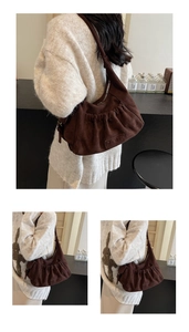 Detail of coffee suede half-moon tote bag featuring gathered bottom and MKMK logo