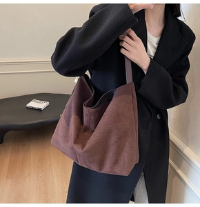 Detail of coffee brown suede tote bag with natural folds and soft drape for commuting