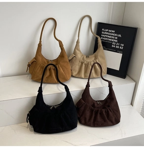 Detailed view of suede tote bags in camel, beige, and coffee with pleated design