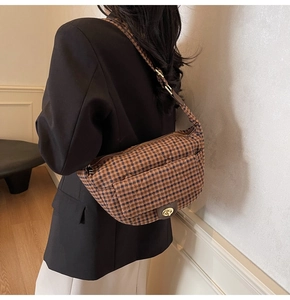Detailed view of the vintage plaid shoulder bag with adjustable strap and metal clasp