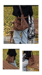 Detail of leopard print hobo bag with leather strap in an autumn park setting