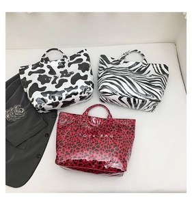 Three animal print tote bags in cow, zebra and leopard patterns with glossy PVC texture