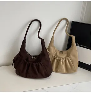 Macro detail of high-quality suede tote bag with signature pleated pocket and metal zipper