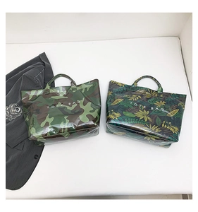 Detail of waterproof camouflage and tropical leaf print tote bags with glossy finish