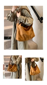 Detailed view of a tan suede oversized tote bag worn by a model in a casual setting