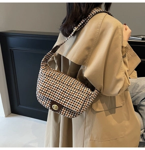 Stylish vintage plaid wool underarm bag worn as a shoulder hobo bag by a model