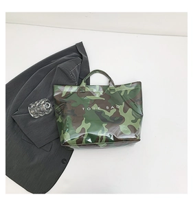 Detailed top view of a camouflage print tote bag with white TOTE BAG text and glossy finish