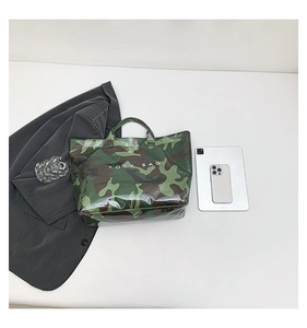Macro view of camouflage tote bag with clear PVC waterproof layer and Tote Bag text