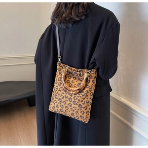 Dettaglio borsa shopper leopardata con manico in bambù e hardware dorato