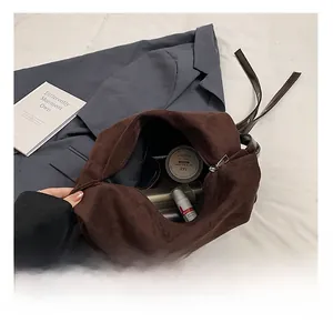 Interior detail of large brown suede tote bag showing spacious capacity and smooth zipper