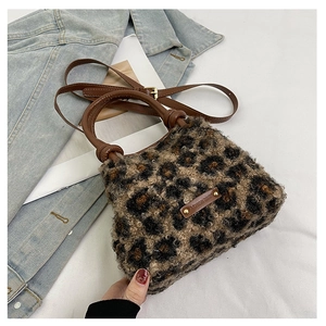 Dettaglio borsa a secchiello peluche leopardata con manici in pelle e finiture in metallo