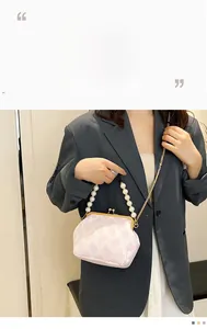 Fashionable pink and white wave pattern handbag with pearl handle and metal chain