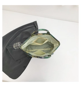 Interior view of tropical leaf print tote bag featuring a zip pocket and open compartment
