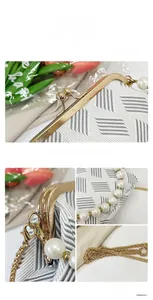 Detail showing vintage golden spherical clasp and pearl handle on a white textured bag