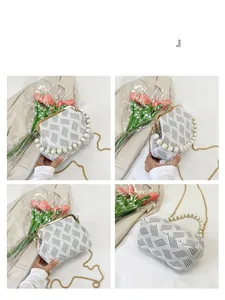 Detail of elegant kiss-lock bag featuring pearl handle and geometric stripe pattern