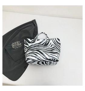 Close-up of zebra pattern tote bag with glossy finish and spacious open interior