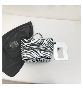 Detail of zebra print tote bag with waterproof glossy finish and large capacity