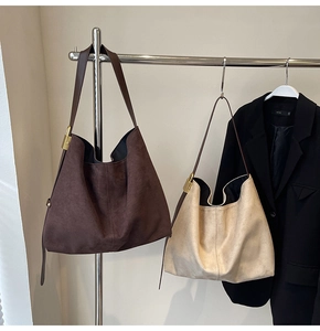 Detailed close-up of premium suede tote bag with metal side buckle and soft matte texture