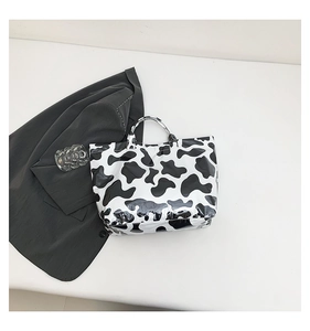 Detail view of large tote bag featuring polished black and white marble pattern finish