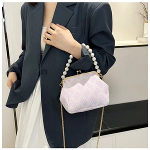 Close-up of pink and white textured crossbody bag with pearl handle and gold chain strap