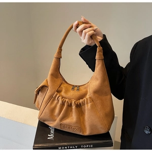 Brown faux suede hobo tote bag featuring side pocket and pleated bottom detail