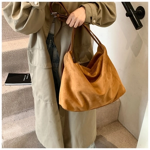Close-up of the large ginger yellow suede tote bag with brown leather shoulder straps