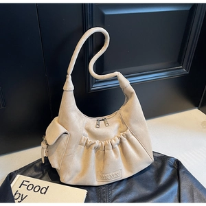 Detail of beige tote bag with drawstring texture and side pocket on black leather