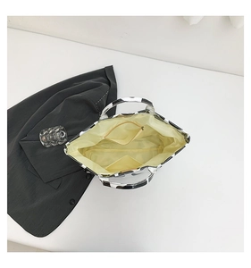 Detailed view of tote bag interior with yellow lining, zipper pocket and cow print exterior