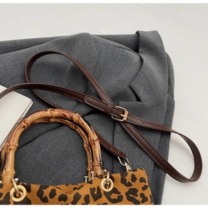 Dettaglio borsa leopardata retrò con manico in bambù e tracolla in pelle marrone
