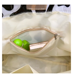 Detailed interior of cow print tote bag with a secure smooth metal zipper pocket