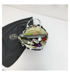 Interior view of large cow print tote bag holding a 13-inch laptop and essentials