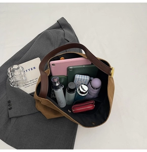 Top view of large brown suede bucket bag interior showing spacious storage for tablet and items