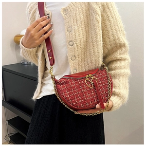 Detail of red tweed belt bag with golden chains and signature round ring zippers
