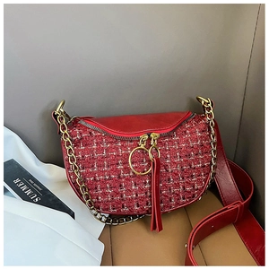 Detail of red tweed waist bag with golden ring zippers and stylish leather tassels
