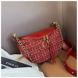 Detail of red tweed handbag with gold chain decoration and unique dual ring zippers