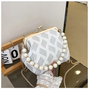 Detail of elegant woven fabric texture with pearl handle and golden metal frame