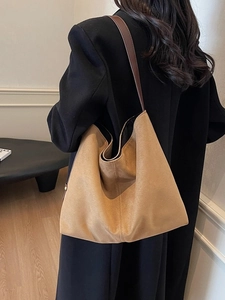 Minimalist large brown suede tote bag for women shown as casual shoulder bucket bag